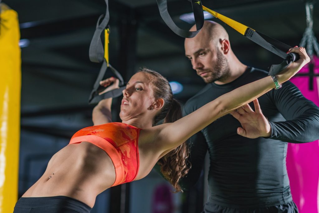 Personal trainer with woman in the gym